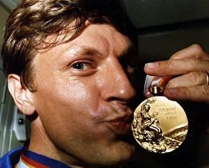 Images Dated 4th October 1988: Sean Kerly kisses his 1988 Olympic gold medal at Heathrow