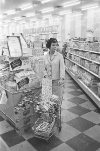 Shopper browsing the aisles at a newly opened self service food store in North London Shopper browsing the aisles at a newly opened self service food store in North London