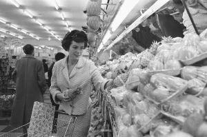 Shoppers browsing the fruit counter at a newly opened self service food store in North Shoppers browsing the fruit counter at a newly opened self service food store in North