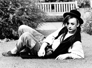 Singer Boy George lying on the grass in his garden. 28th September 1982 Singer Boy George lying on the grass in his garden. 28th September 1982