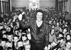 Singer Tom Jones was presented with an old school bell by two youngsters at his old Singer Tom Jones was presented with an old school bell by two youngsters at his old