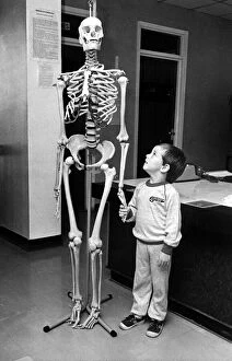 Images Dated 10th September 1985: A small child holding hands with a skeleton on 10th September 1985