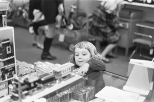 Small girl looks on longingly at the latest Lego set in the toy department of Heelas Small girl looks on longingly at the latest Lego set in the toy department of Heelas