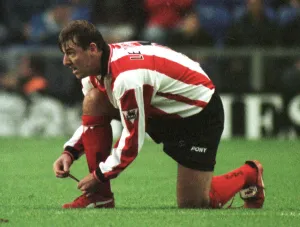 Southampton footballer Matthew Le Tissier putting on red boots during his side' Southampton footballer Matthew Le Tissier putting on red boots during his side'