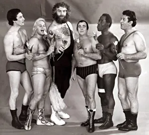 Sport. Wrestling Men in Lycra singing with flowers wearing assorted trunks July Sport. Wrestling Men in Lycra singing with flowers wearing assorted trunks July