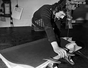 A staff member uses a 20 foot long band kinfe to cut accurately round a pattern at A staff member uses a 20 foot long band kinfe to cut accurately round a pattern at