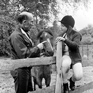 Sterling Moss (Ex Racing Driver). Seen here with horse and daughter. June 1974 S74-3861 Sterling Moss (Ex Racing Driver). Seen here with horse and daughter. June 1974 S74-3861