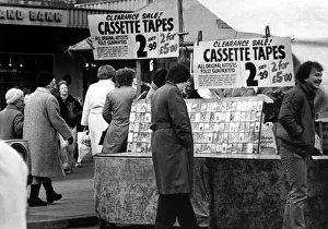 A street trader selling counterfeit cassette tapes from a stall in the Bigg Marker A street trader selling counterfeit cassette tapes from a stall in the Bigg Marker