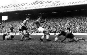 striker Derek Tapscott watched by Everton's Brian Labone - 9th Dec 1961 striker Derek Tapscott watched by Everton's Brian Labone - 9th Dec 1961