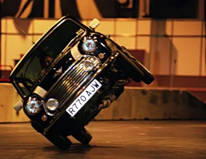 Stunt driver performs a stunt in a mini cooper motor car at the Exhibition Centre for Stunt driver performs a stunt in a mini cooper motor car at the Exhibition Centre for