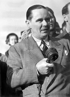 Sunday times golfing correspondant Henry Longhurst with microphone in hand at a meeting Sunday times golfing correspondant Henry Longhurst with microphone in hand at a meeting