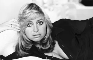 Susan George actress lying on a bed on her side holding her head up with her fingers Susan George actress lying on a bed on her side holding her head up with her fingers