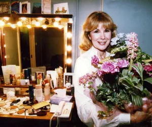 Susan Hampshire holding bouquet of flowers in her dressing room after appearing in Noel Susan Hampshire holding bouquet of flowers in her dressing room after appearing in Noel
