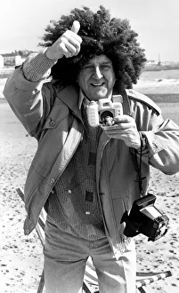 Television comedian Norman Collier wearing a funny wig on the beach April 1991 Television comedian Norman Collier wearing a funny wig on the beach April 1991