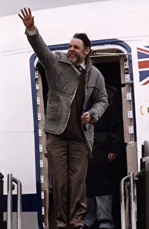 Terry Waite Waves his arm as he is about to get into the plane Terry Waite Waves his arm as he is about to get into the plane