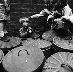 Three-year-old Robert Watson plays in the dustbin outside Number Two Court Three-year-old Robert Watson plays in the dustbin outside Number Two Court