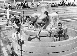 Images Dated 1st August 1972: Time to cool off because, for once, the sun is shining. children splash about inTynemouth