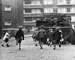 Toddlers in Merseyside running after National Coal Board Lorries and trying to jump Toddlers in Merseyside running after National Coal Board Lorries and trying to jump