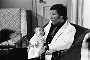 Tom Jones with his grandson Alexander, aged eleven months, in their London hotel Tom Jones with his grandson Alexander, aged eleven months, in their London hotel