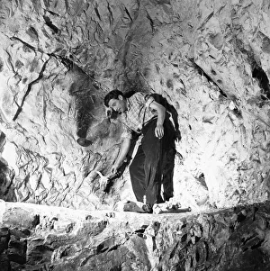 Tourist in the West Wycombe Caves also known as The Hell Fire Caves which are a network Tourist in the West Wycombe Caves also known as The Hell Fire Caves which are a network