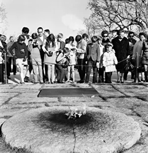 Tourists with their cameras observe the eternal flame at the grave of slain American Tourists with their cameras observe the eternal flame at the grave of slain American