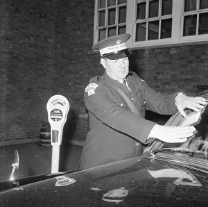 Traffic warden during training sticking fine on window screen parking clock Traffic warden during training sticking fine on window screen parking clock