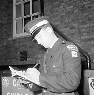 Traffic warden during training writing a fine fining uniform Traffic warden during training writing a fine fining uniform