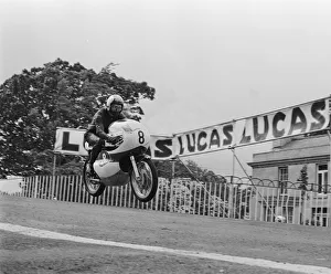 TT Races 250cc Lightweight International. Mike Duff goes over Ballaugh Bridge TT Races 250cc Lightweight International. Mike Duff goes over Ballaugh Bridge
