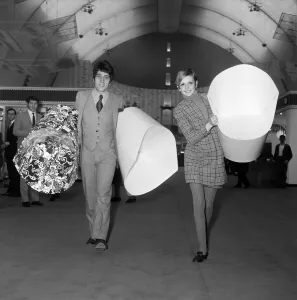 Twiggy with her manager, Justin de Villeneuve carrying some of the paper chairs at Twiggy with her manager, Justin de Villeneuve carrying some of the paper chairs at