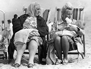 A typical British summer holiday scene - a family wrapped up against the cold in A typical British summer holiday scene - a family wrapped up against the cold in