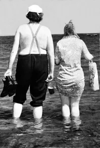 Typical Geordie couple Bill and Effie walk in the sea - Bill has his bottle of Brown Ale Typical Geordie couple Bill and Effie walk in the sea - Bill has his bottle of Brown Ale