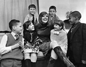 Images Dated 21st December 1970: Underpriviledged children at the Palladium. Singer Cilla Black wth six of the children