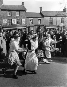 A view of a village pancake race in action. February 1951 P005030 A view of a village pancake race in action. February 1951 P005030