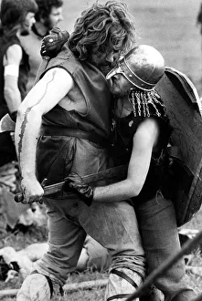 A Viking about to deliver the final blow in a struggle with a Saxon at a Viking battle A Viking about to deliver the final blow in a struggle with a Saxon at a Viking battle