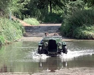 A vintage car passes through the ford at Coughton near Alcester A vintage car passes through the ford at Coughton near Alcester
