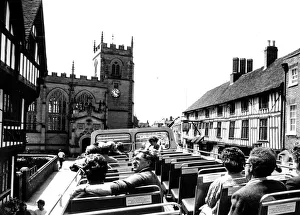 Visitors relaxing on the open-top bus as it travels through the streets of Visitors relaxing on the open-top bus as it travels through the streets of