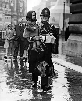 VJ Day, a policeman carries a lost child in Trafalgar Square, London. 15th August 1945 VJ Day, a policeman carries a lost child in Trafalgar Square, London. 15th August 1945