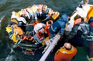 Images Dated 1st September 1992: Volunteers clamber into the new life raft during a mock evacuation of the cross Tyne