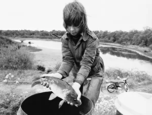 Weather drought boy rescues a carp at Coleshill Pool Warwickshire dbase msi Weather drought boy rescues a carp at Coleshill Pool Warwickshire dbase msi