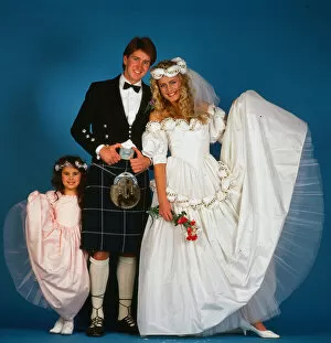 Images Dated 12th February 1987: Wedding dress fashion, February 1987 Model wearing wedding dress with groom wearing