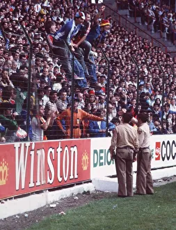 West Germany v Chile fans World Cup 1982 football supporters standing on fence police West Germany v Chile fans World Cup 1982 football supporters standing on fence police