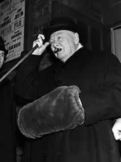 Winston Churchill wearing a hand muff as he leaves the Scala theatre in London where he Winston Churchill wearing a hand muff as he leaves the Scala theatre in London where he