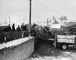The winter of 1946 - 1947 Coal being loaded from the pit tubs onto waiting empty The winter of 1946 - 1947 Coal being loaded from the pit tubs onto waiting empty