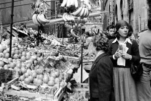 Woman buying fresh fruit and vegetables in a poor suburb on the outskirts of Rome Woman buying fresh fruit and vegetables in a poor suburb on the outskirts of Rome