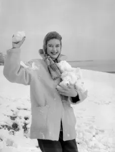 A woman having a snowball fight with her friend on Hastings beach. 8th March 1955 A woman having a snowball fight with her friend on Hastings beach. 8th March 1955