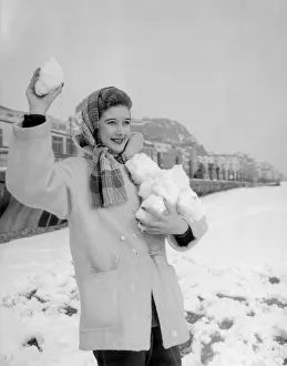 A woman having a snowball fight with her friend on Hastings beach. 8th March 1955 A woman having a snowball fight with her friend on Hastings beach. 8th March 1955