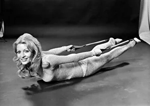 Woman lying on the floor doing slimming exercises. January 1971 Woman lying on the floor doing slimming exercises. January 1971