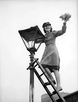 Woman Railway Porter cleaning a lamp 1941 women doing mens jobs during the war Woman Railway Porter cleaning a lamp 1941 women doing mens jobs during the war