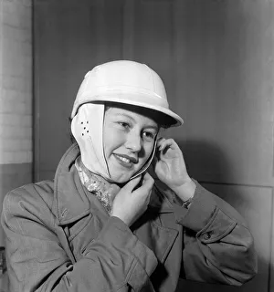 Woman strapping on her crash helmet. October 1952 C5018 Woman strapping on her crash helmet. October 1952 C5018