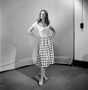 Woman wearing checked checked skirt and white short sleeved top Woman wearing checked checked skirt and white short sleeved top